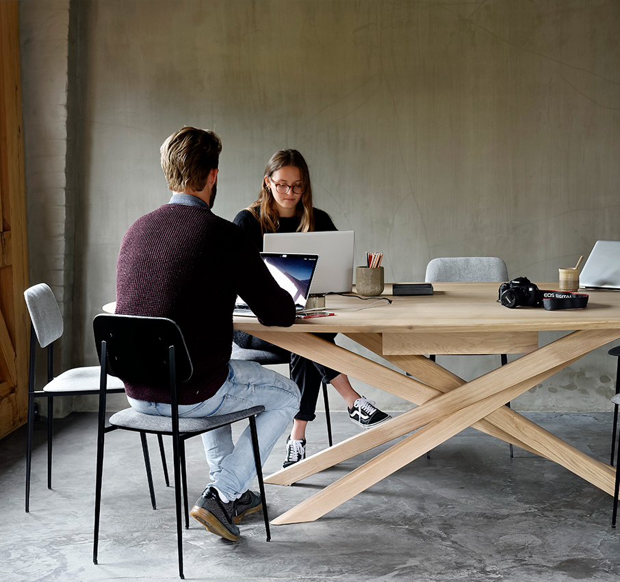 Live Light | Employees working together in a business meeting room designed with the Mikado meeting table and DC dining chairs